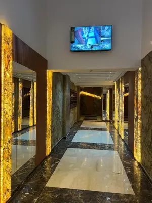 a hallway with a television in a building at Twin Center View Apt in Maarif in Maarif
