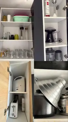 a kitchen cabinet with various appliances in it at Twin Center View Apt in Maarif in Maarif