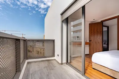 a bedroom with a bed and a balcony at Prestigieux appartement 3 chambre plein cœur CFC in Casablanca
