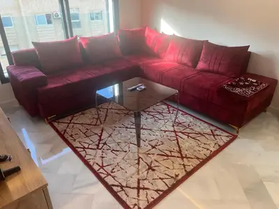 a living room with a red couch and a glass table at Proche chekh khalifa KLIVING Studio in Casablanca