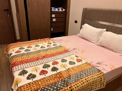a bed with a colorful quilt on top of it at Proche chekh khalifa KLIVING Studio in Casablanca