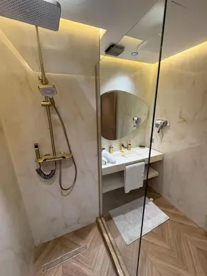 a bathroom with a shower with a sink and a mirror at Appartement haut standing Casablanca in Casablanca