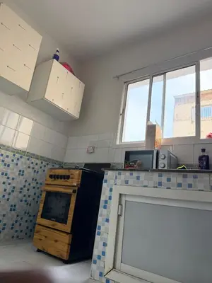 a kitchen with blue and white tiles on the counter at Résidence Haja in Casablanca