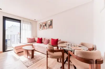 a living room with a couch and a table at Studio Signature - Parking privé & neuf in Casablanca