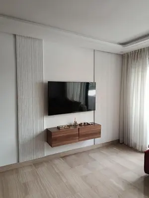a living room with a television on a wall at Studio Casablanca Les Princesses amirat in Maarif