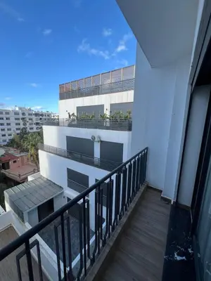 a balcony of a building with a view of a city at Studio Casablanca Les Princesses amirat in Maarif