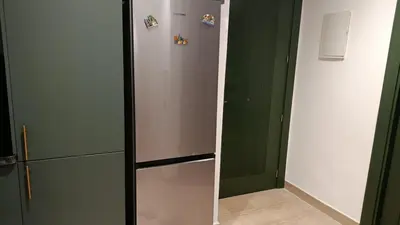 a kitchen with a refrigerator with magnets on it at Studio Casablanca Les Princesses amirat in Maarif