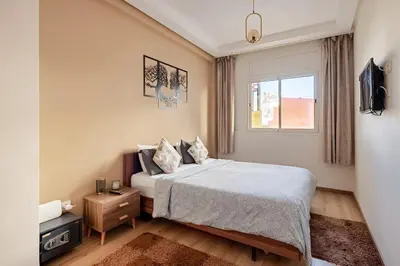 a small bedroom with a bed and a window at Appartement spacieux Océan Rabat in Rabat
