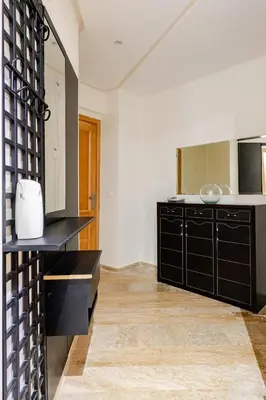 a kitchen with black cabinets and a mirror at Appartement spacieux Océan Rabat in Rabat