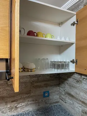 a cupboard with many plates and glasses on it at Appartement bord de mer avec piscine à Bouznika in Bouznika