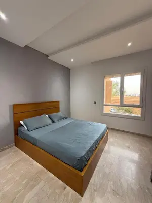 a bedroom with a bed and a window at Evasion apartment with beach and pool views in Bouznika