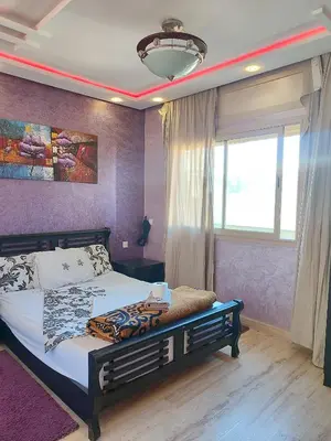 a bedroom with a bed and a large window at Casablanca House hassan2 in Casablanca