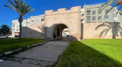 a person standing in front of a building at Elégance &Confort Agdal in Rabat