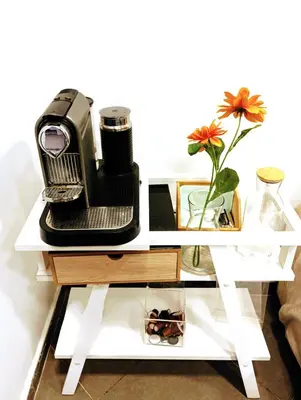 a coffee table with a heater and a flower on it at Elégance &Confort Agdal in Rabat