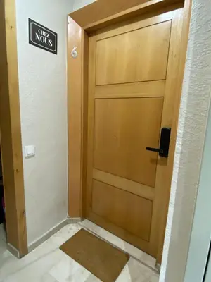 a wooden door in a hallway with a sign on it at Modern Studio Centre Casa belvédère Tramway & Train Station in Casablanca