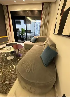 a living room with a large ottoman in front of a couch at A 1 pas de Zara Studio Centrale et Design in Casablanca