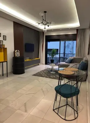 a living room with a table and a couch at A 1 pas de Zara Studio Centrale et Design in Casablanca