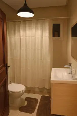 a bathroom with a toilet and a sink at Casa Bourgogne 2-Bedroom apart, Guarded community in Casablanca