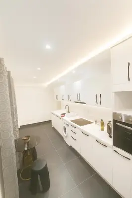 a white kitchen with a sink and a dishwasher at Casa Bourgogne 2-Bedroom apart, Guarded community in Casablanca