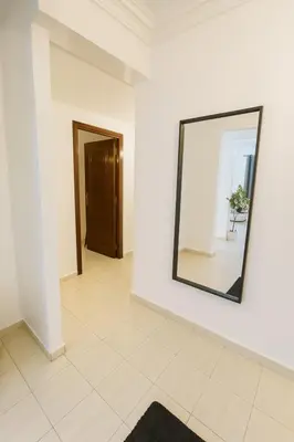 a mirror on a white wall in a room at Casa Bourgogne 2-Bedroom apart, Guarded community in Casablanca