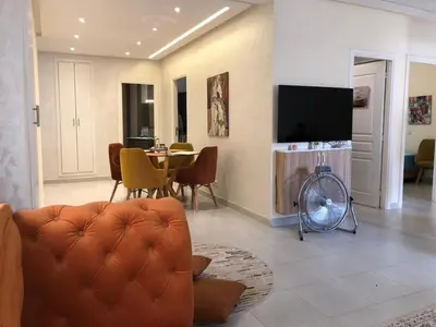 a living room with a couch and a table at AFCON near rabat complex de football in Bouznika