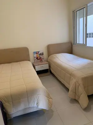 a bedroom with two beds and a window at AFCON near rabat complex de football in Bouznika