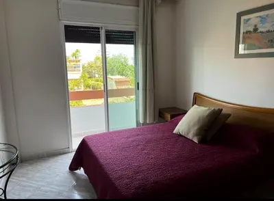 a bedroom with a bed with a purple blanket at Resedence lettoral in Mohammedia