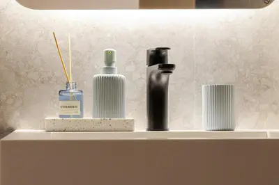 a shelf with three bottles on it with a lamp at Loft - Literie Premium, Fibre optique, IPTV, GYM, Terrasse in Casablanca