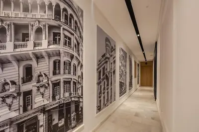 a hallway with black and white paintings on the walls at Loft - Literie Premium, Fibre optique, IPTV, GYM, Terrasse in Casablanca