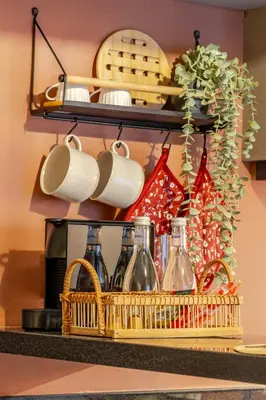 a shelf with bottles and cups and a basket at Loft - Literie Premium, Fibre optique, IPTV, GYM, Terrasse in Casablanca