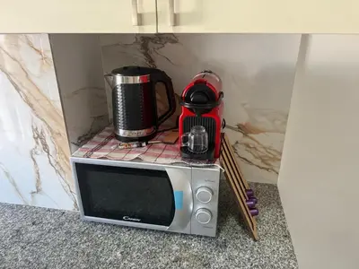 a microwave with a coffee maker on top of it at Lumineux cosy appartement - océan Rabat in Rabat