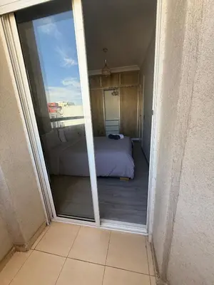 a view of a bedroom from the door of a balcony at Lumineux cosy appartement - océan Rabat in Rabat