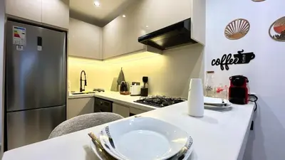 a kitchen with a counter with a refrigerator and a stove at Luxurious studio with unobstructed view in Casablanca