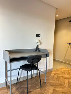 a desk with a chair and a lamp on it at Carrington Stay 13 in Casablanca