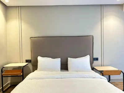 a bedroom with a large bed with white sheets and pillows at Carrington Stay 13 in Casablanca