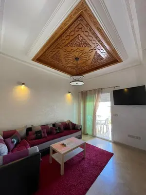 a living room with a couch and a table at Saad in Mohammedia