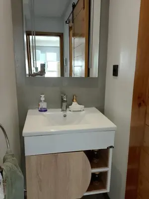 a bathroom with a white sink and a mirror at Confort et mer Océan Rabat in Rabat