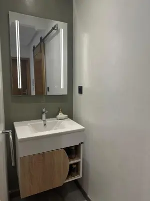 a bathroom with a white sink and a mirror at Confort et mer Océan Rabat in Rabat