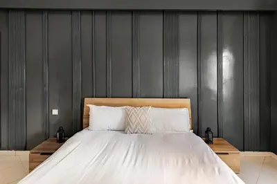 a bedroom with a large bed with a wooden headboard at Authentic & Spacious 2 Bedrooms Heart of Rabat in Rabat