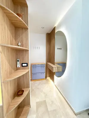 a room with a hallway with wooden shelves and a sink at Charmante maison de vacances proche de la plage à quelques minutes de Rabat in Temara