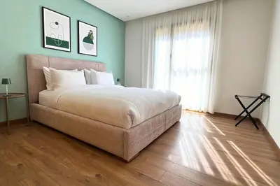 a bedroom with a large bed and a large window at Luxury Apartment with a Stunning Sea View - Rabat in Rabat