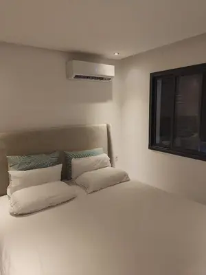 a bedroom with a white bed with a window at 2 min walk from Four Seasons Hotel-Cozy Terrace Stay in the Heart of Rabat in Rabat