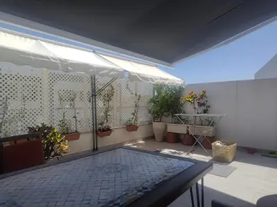 a patio with potted plants on a wall at 2 min walk from Four Seasons Hotel-Cozy Terrace Stay in the Heart of Rabat in Rabat