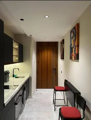 a kitchen with a sink and two stools in a room at A Wonderful Escape In Morocco in Casablanca