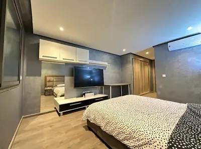 a bedroom with a bed and a flat screen tv at RDJ 2CH haut standing - Bouskoura in Bouskoura