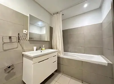 a white bathroom with a sink and a tub and a tubermott at RDJ 2CH haut standing - Bouskoura in Bouskoura