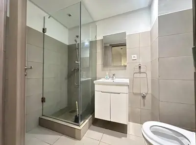 a bathroom with a shower and a toilet and a sink at RDJ 2CH haut standing - Bouskoura in Bouskoura