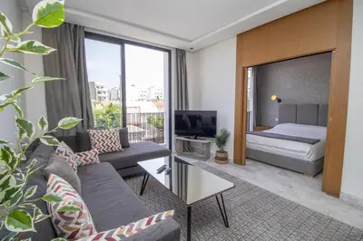 a living room with a couch and a bed at B5 Modern bright studio with city view in Casablanca