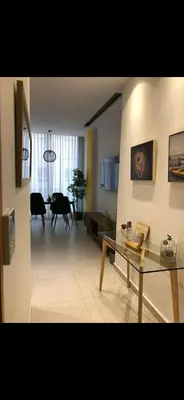 a living room with a table and a dining room at Studio lumineux et cosy in Casablanca