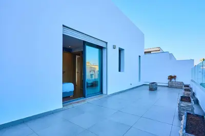 a white house with a balcony with blue lights at Terrasses and Sunset Duplex Luxe 3 Bed in Ghandi in Casablanca
